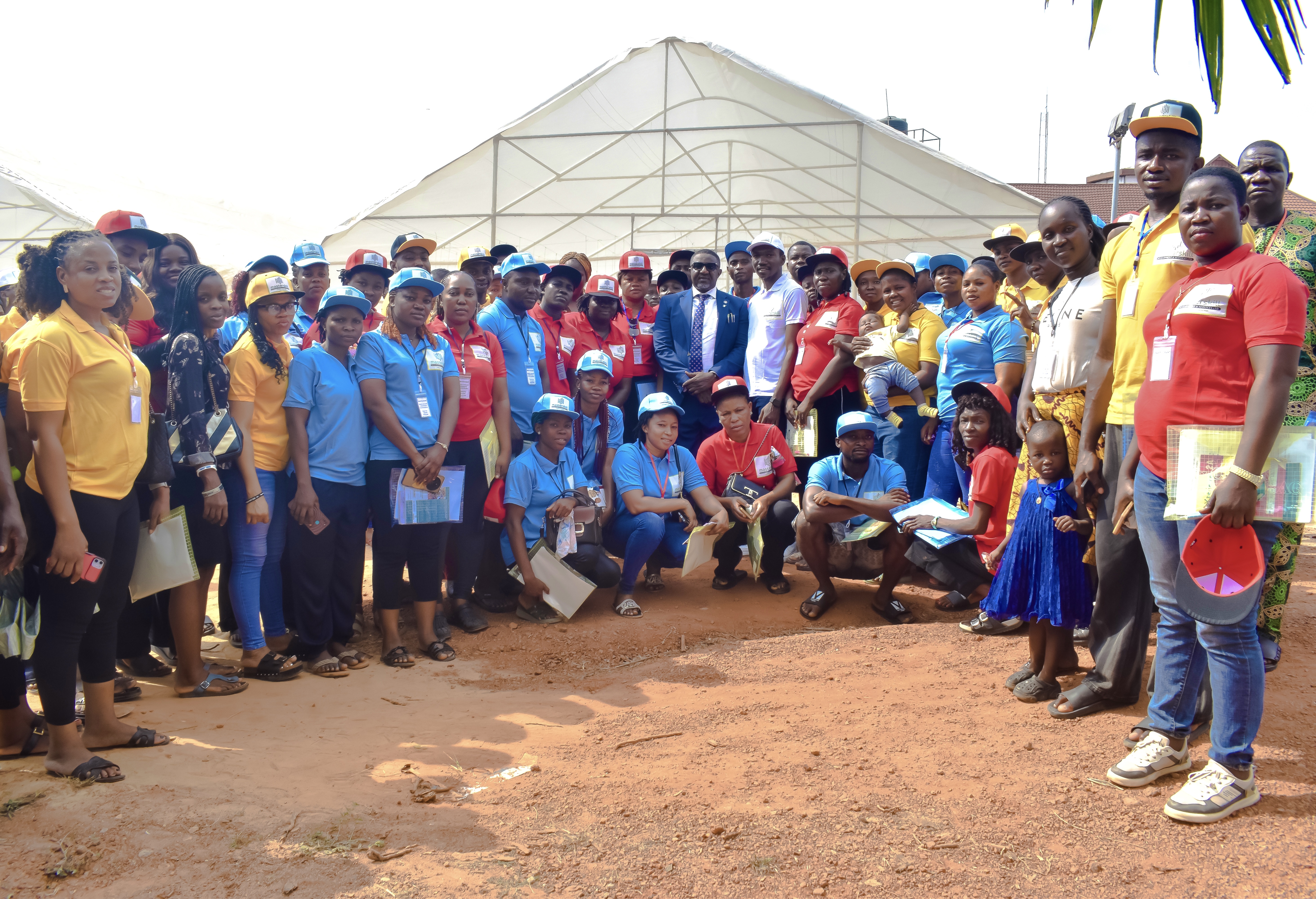 EWAS cooperative members in their colorful uniforms gathered at the greenhouse cluster
